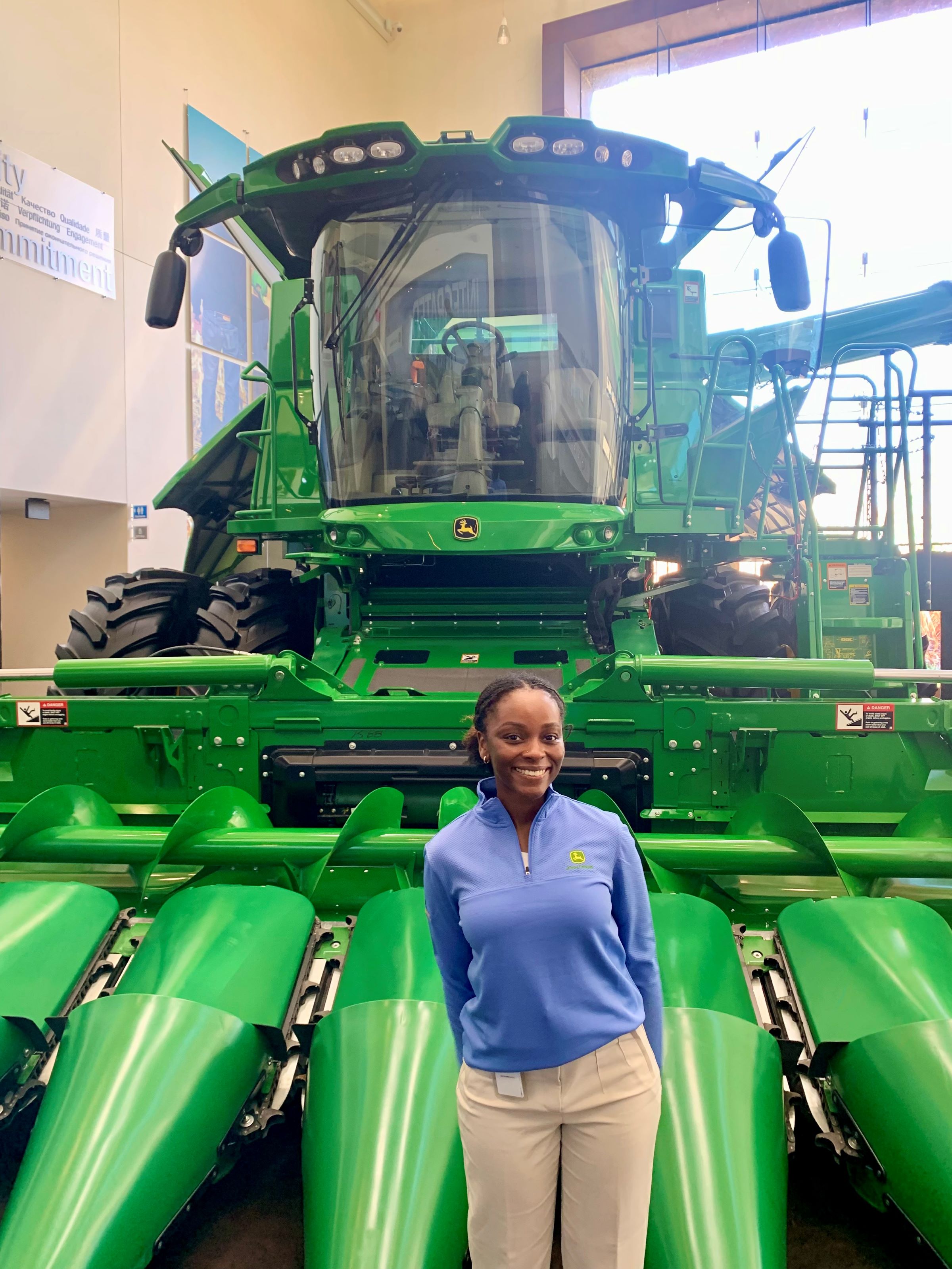 Caitlyn McFadden pictured standing in front of John Deere machinery. Photo provided by Caitlyn McFadden