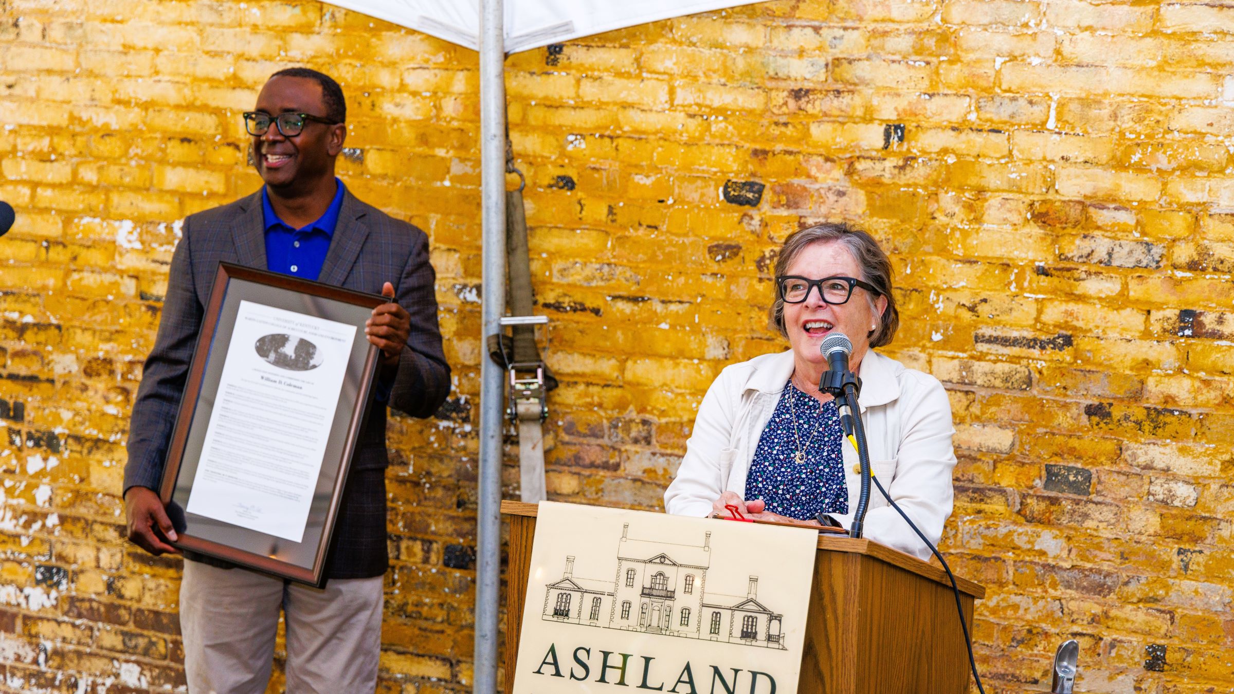 Dean Nancy Cox presenting the official William D. Coleman resolution to grandson, Jim Coleman. Photo by Matt Barton.