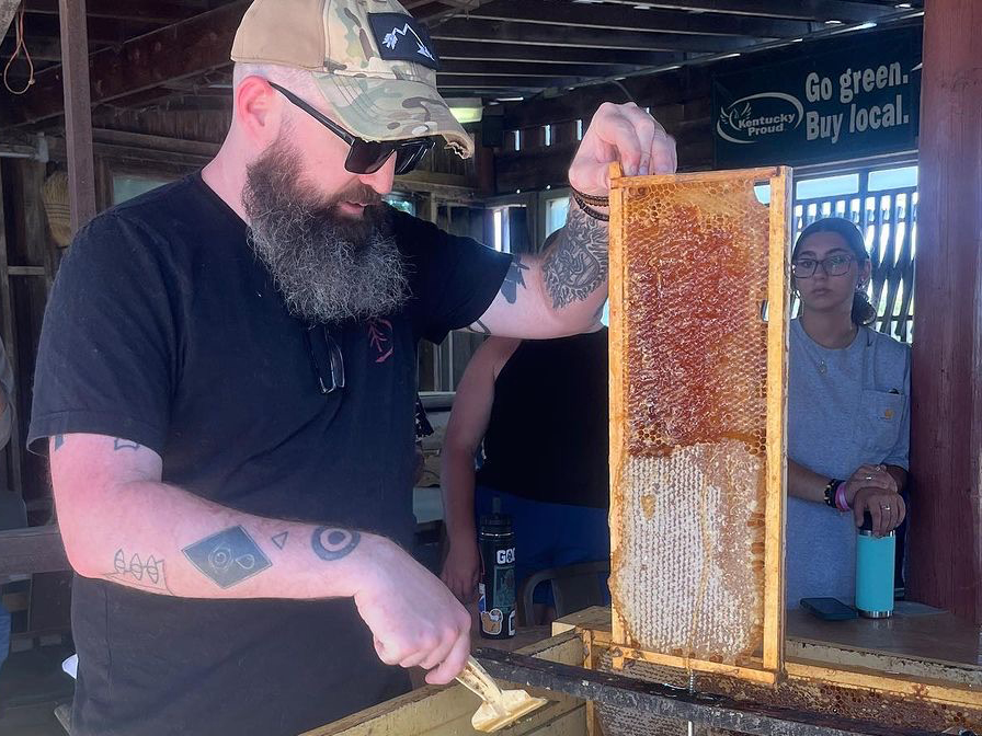 Agriculture junior Brad Lykins helps to extract honey during a beekeeping class as part of his work with UK’s CSA—community supported agriculture—organization. (Photo by Kristi Durbin, UK CSA)