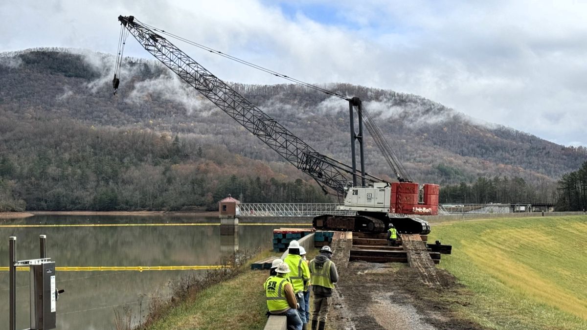 Crane set up on the North Fork reservoir placing barges in the reservoir. Photo provided by Robert Frank.
