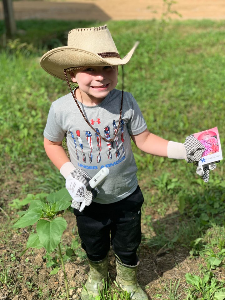 A young boy prepares to grow a Victory Garden with tools and seeds he received from Perry County NEP assistant, Reda Fugate.