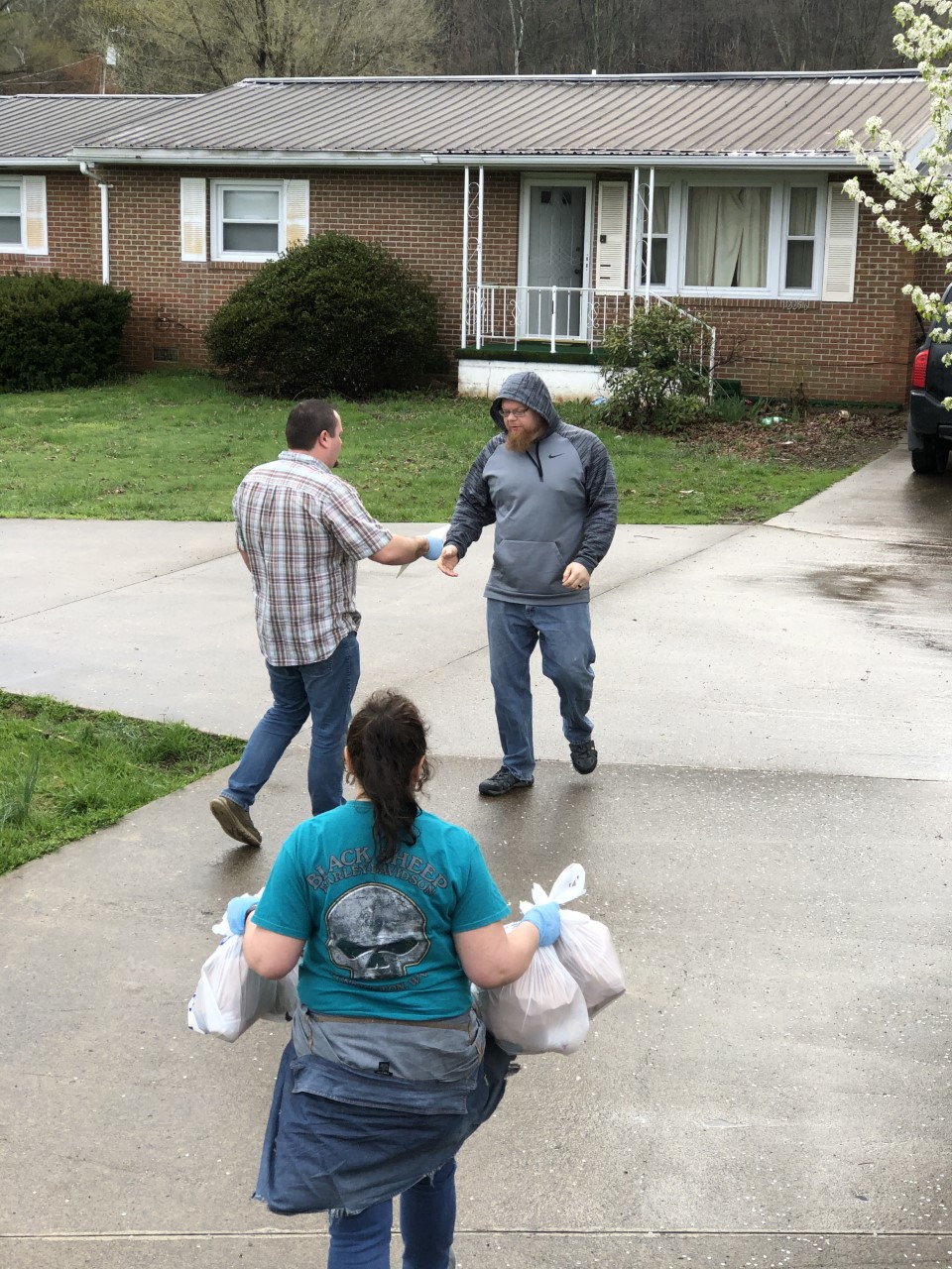 Lewis County NEP assistant Brad Stone, ctr left, distributes food to clientele early in the pandemic.