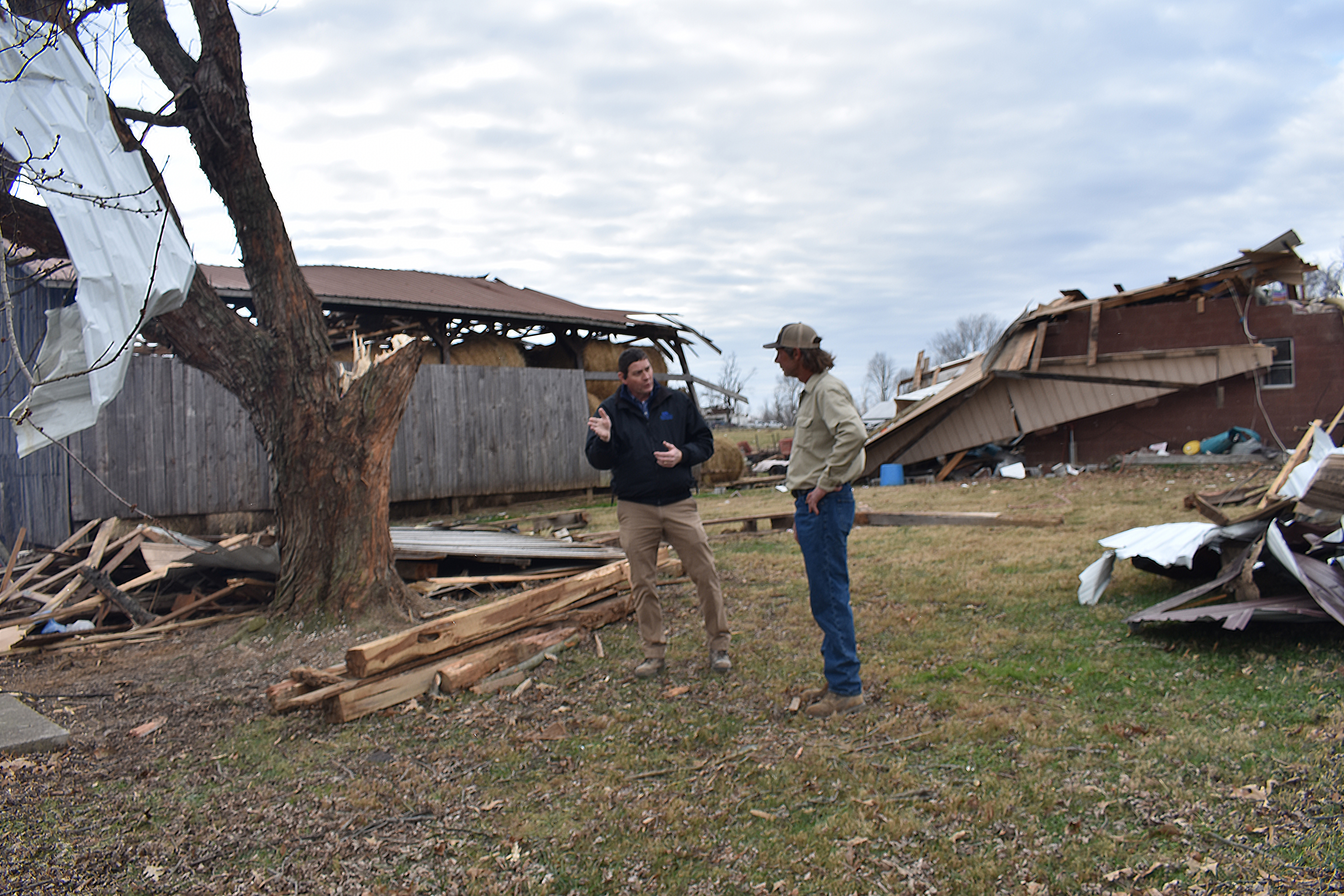 Darrell Simpson, Muhlenberg County agriculture and natural resources extension agent, speaks with Bremen farmer Kenny Smith about the tornado damage to Smith's property. Photo by Katie Pratt, UK agricultural communications.