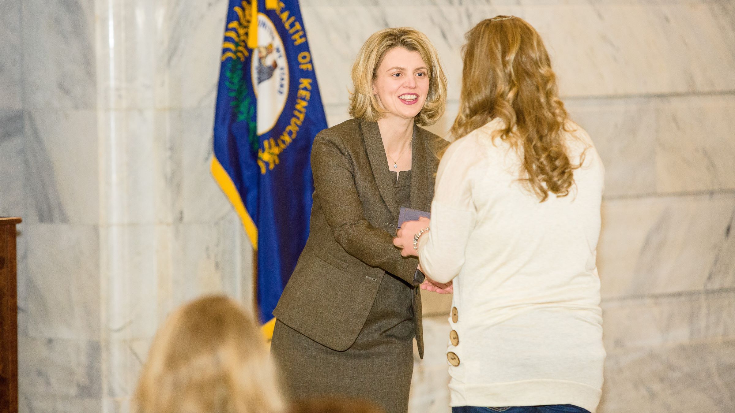 Jennifer Hunter presenting an award at an event in the Kentucky Capitol Rotunda. Photo by Matt Barton.