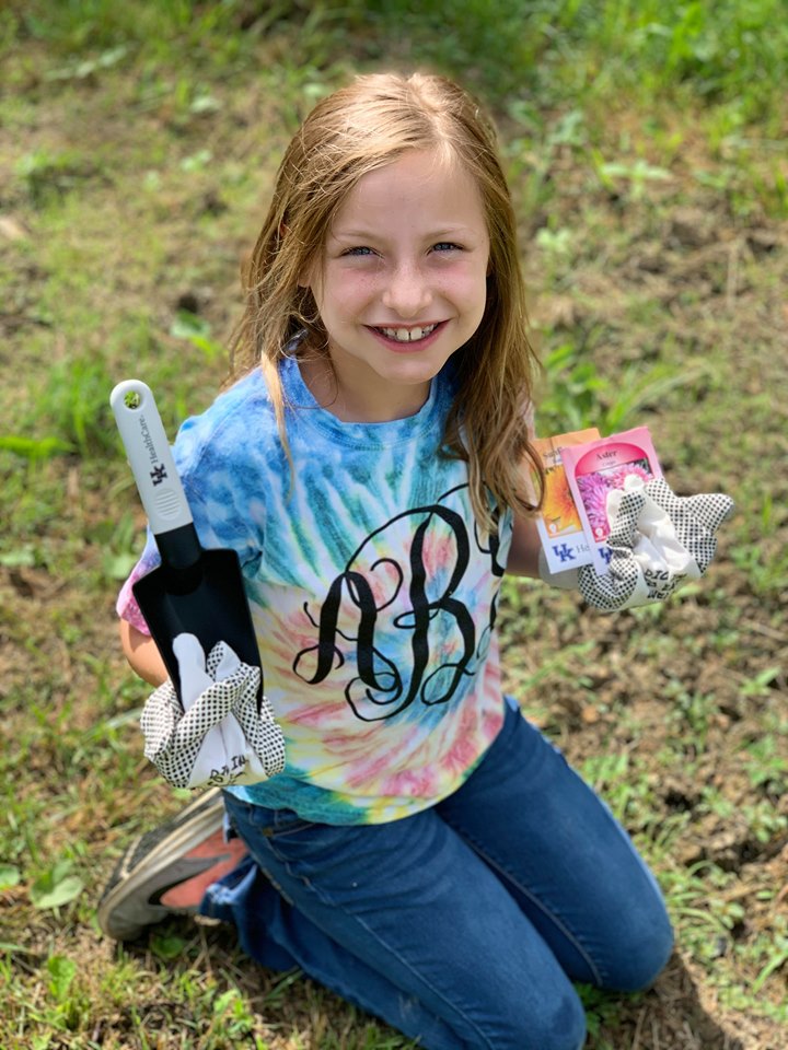A young girl prepares to grow a Victory Garden with tools and seeds he received from Perry County NEP assistant, Reda Fugate.