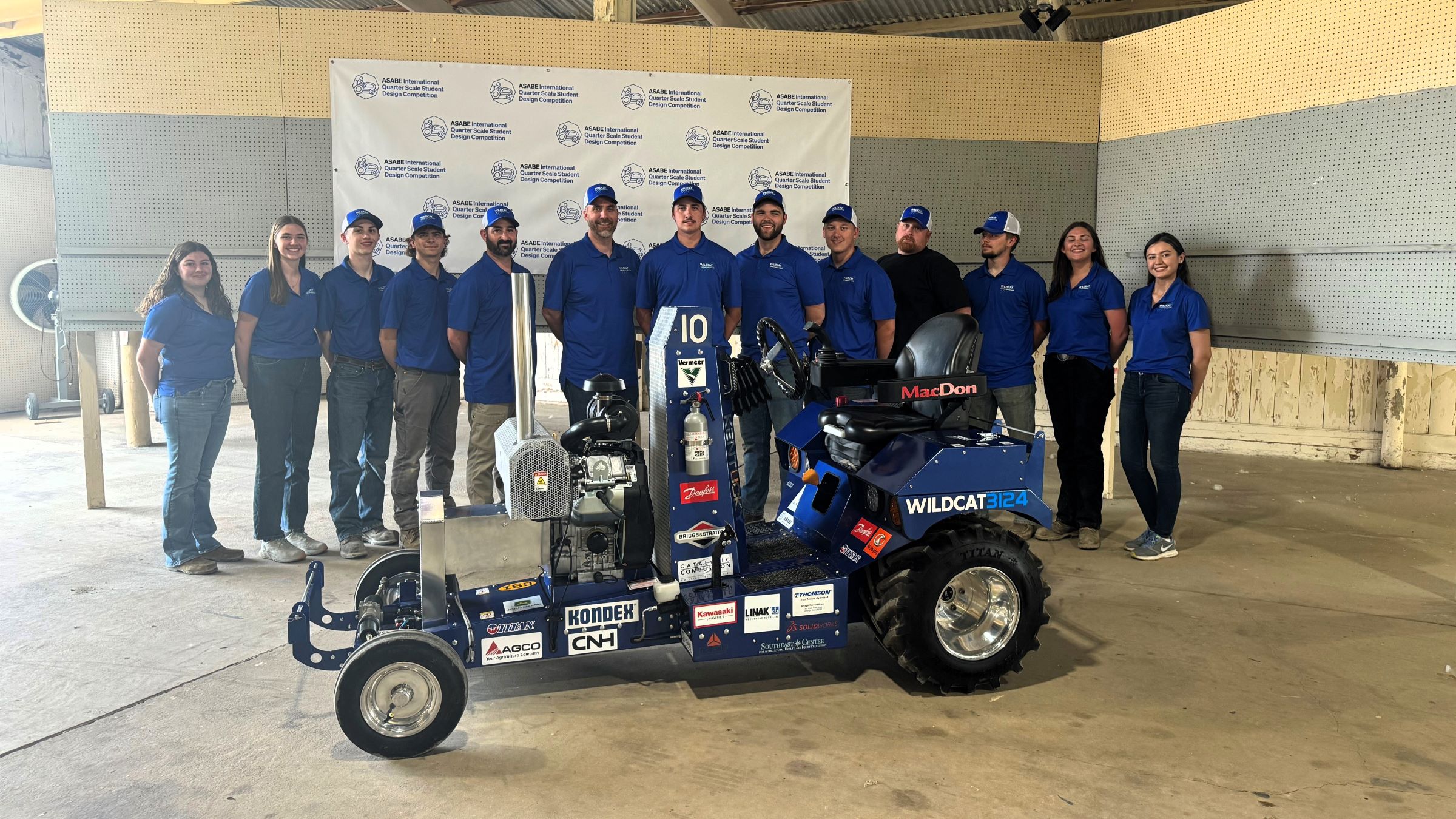 Wildcat Pulling Team standing with the tractor they built