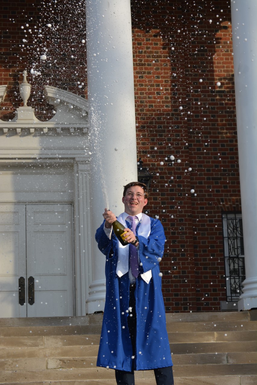 Zachary Chaney celebrates graduation with a bottle of champagne on the steps of UK's Memorial Hall. Photo provided by Zachary Chaney