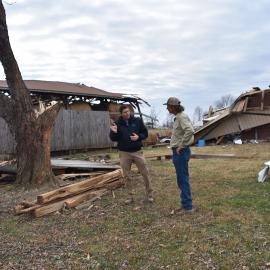 Darrell Simpson, Muhlenberg County agriculture and natural resources extension agent, speaks with Bremen farmer Kenny Smith about the tornado damage to Smith's property.  Photo by Katie Pratt, UK agricultural communications.