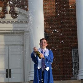Zachary Chaney celebrates graduation with a bottle of champagne on the steps of UK's Memorial Hall.  Photo provided by Zachary Chaney