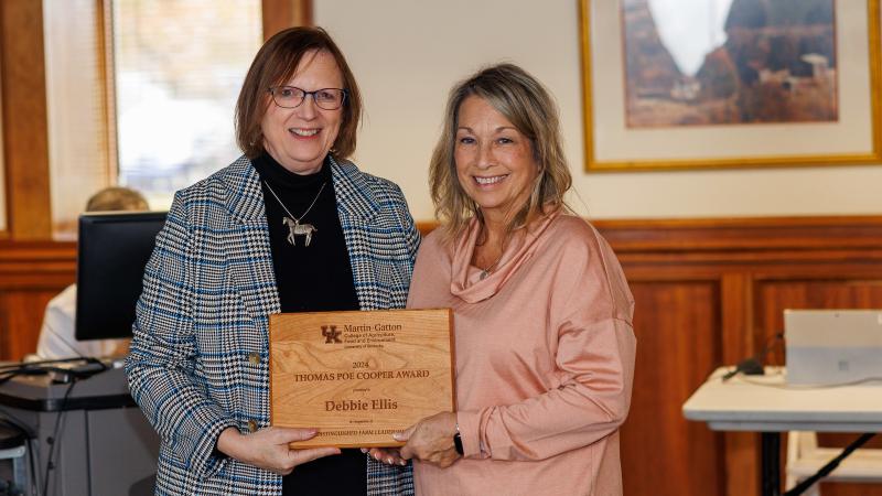 Laura Stephenson, left, presenting wooden plaque award to Debbie Ellis.