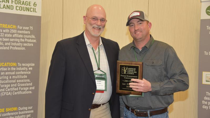 Hamilton (right) with Ronnie Holman, president of the American Forage and Grassland Council.