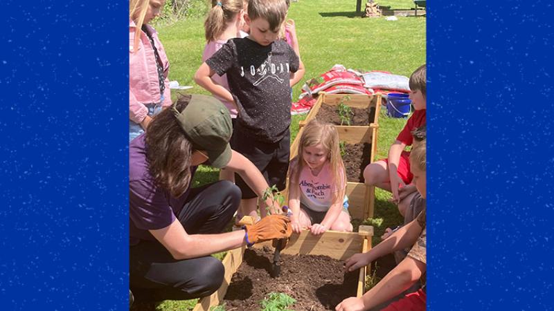 W.B. Muncy students plant tomatoes with a UK intern. Photo provided by McKenzie Fox-Potter.