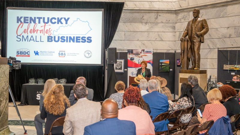 A group of people watching small business presentation at the Kentucky State Capitol in the rotunda.