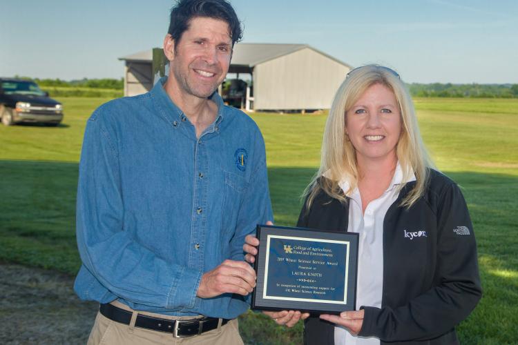 Bill Bruening of the UK Wheat Science Group presents Laura Knoth with the group's Service Award during the UK Wheat Field Day. Photo by Steve Patton, UK agricultural communications.