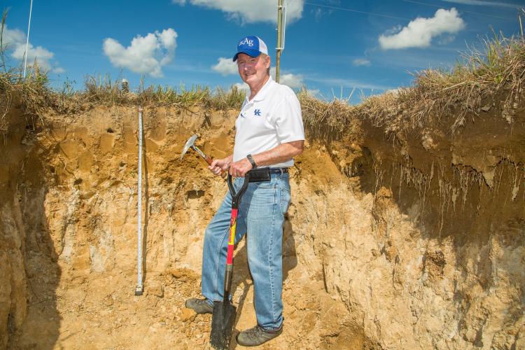 UK soil scientist Lloyd Murdock shows the fragipan layer found in the soil in a pit at the UK Research and Education Center in Princeton. Photo by Stephen Patton, UK agricultural communications.