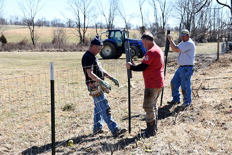 Livestock farmers from Campbell and Pendleton counties helped repair fences on Muhlenberg County livestock farms destroyed by the Dec. 10 tornadoes. The Campbell and Pendleton farmers experienced a devastating tornado 10 years ago. Photo by Katie Pratt. 