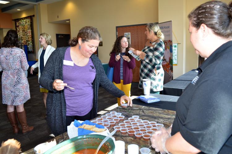 Shonda Johnston, Clark County family and consumer sciences extension agent, tries some venison chili during the recent Cook Wild Kentucky launch party. Photo by Katie Pratt, UK agricultural communications.