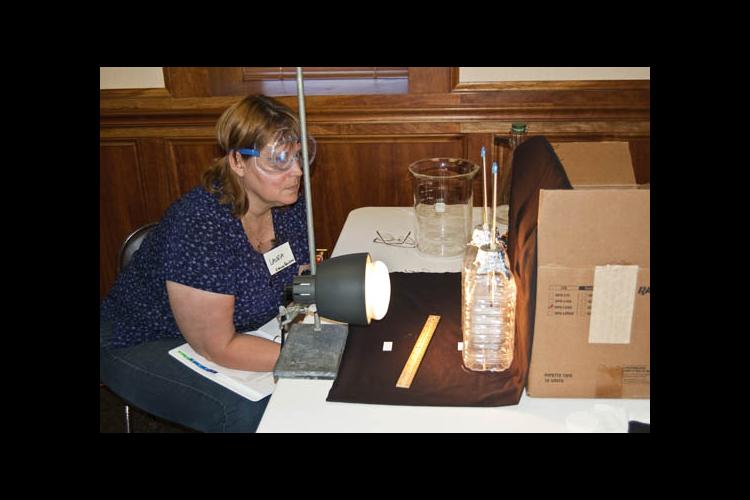 Laura Lang measures temperature difference between carbon dioxide and air. 