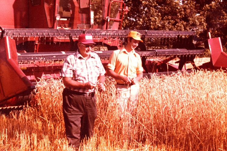 No-till pioneer Harry Young and his son John Young in a field of wheat during harvest. Photo courtesy of Alexander Young.