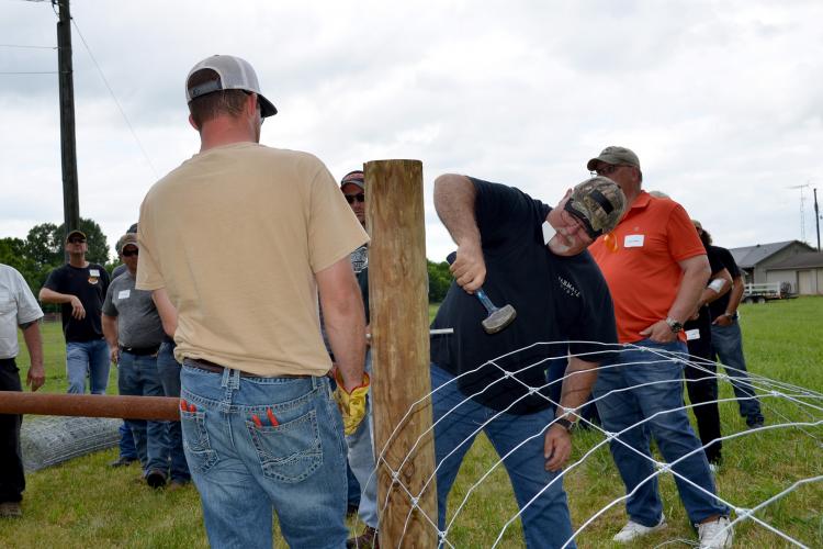 Butch King, Kentucky Fencing School participant, participates in a on-site fence construction demonstration in Logan County. Photo by Katie Pratt, UK agricultural communications.