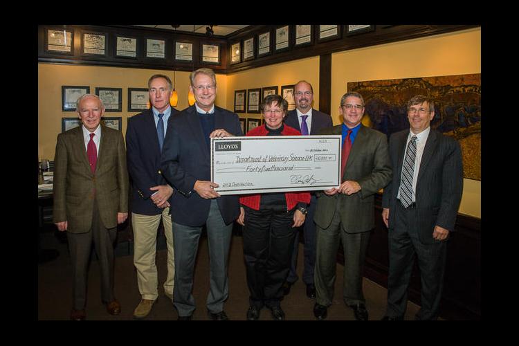 UK representatives receive a check from Bill Wallace, Pat Talley and Ken Maier of Lloyd's of London. 