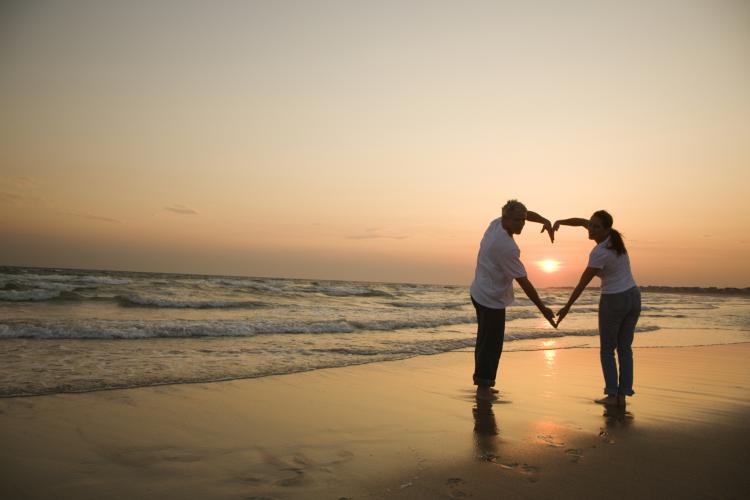 couple on beach with sunset