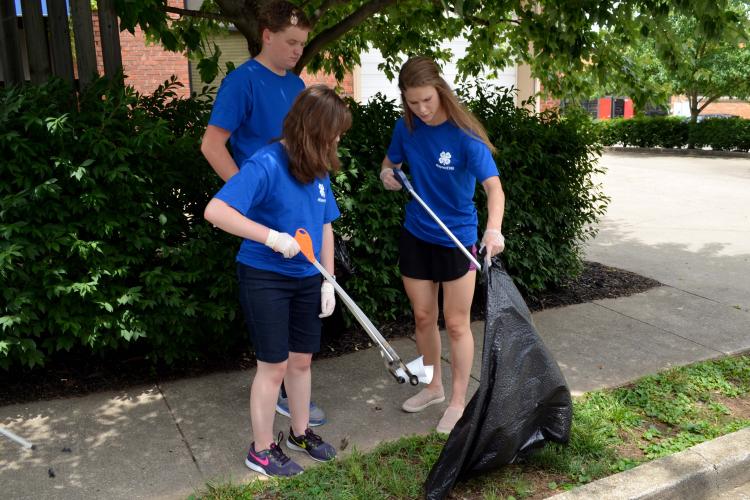 Kentucky 4-H'ers pick up litter in a Lexington community as part of their community service project at 4-H Teen Conference.