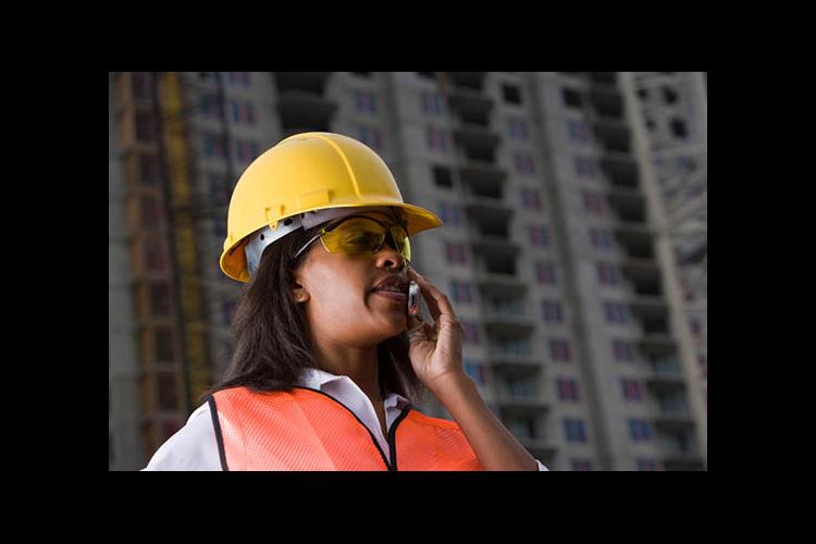 Woman on phone at construction site 