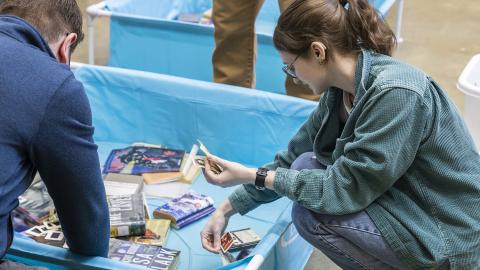 Looking through wet photos at a workshop