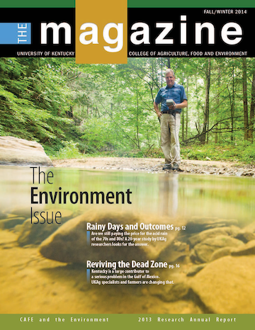 Cover of the AgMagazine for Fall/Winter 2014. Cover photo displays person standing near a small pond with equipment.