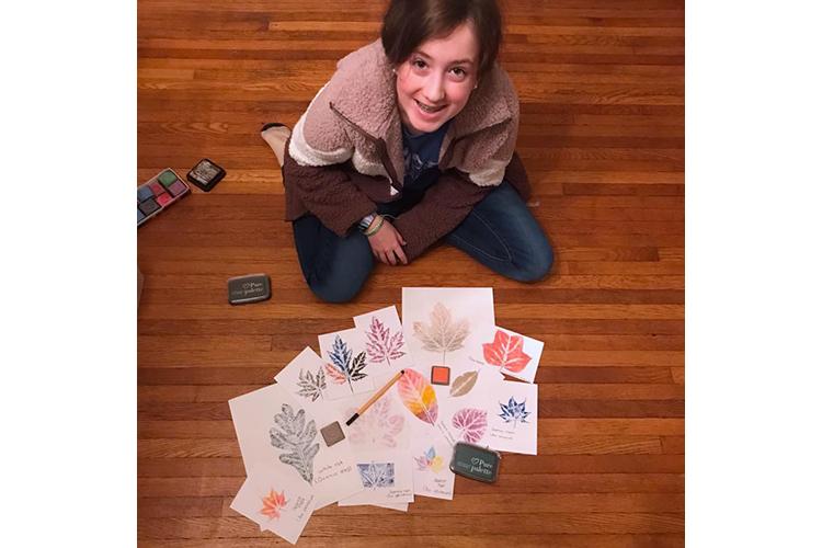 Carroll County 4-H'er Brenna Mefford shows off her leaf print collection that she made in another 4-H program. 4-H'ers who become Junior Master Naturalists will make a similar collection. Photo provided.