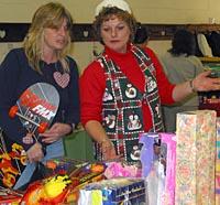 EFNEP Assistant Brenda Childers helps a client pick out gifts for her children at the Toy Store.
