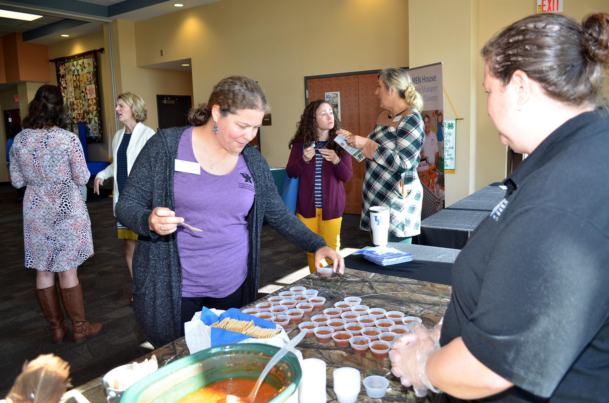 Shonda Johnston, Clark County family and consumer sciences extension agent, tries some venison chili during the recent Cook Wild Kentucky launch party. Photo by Katie Pratt, UK agricultural communications.