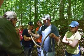instructor in woods with snake