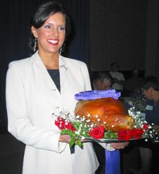 MacKenzie Mayes, Miss Kentucky 2003, displays this year's Grand Champion Ham at the breakfast. 