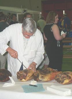 A judge examines hams during the second 4-H ham contest that was held in Cloverville, located in the West Wing of the Kentucky State Fair and Exposition Center