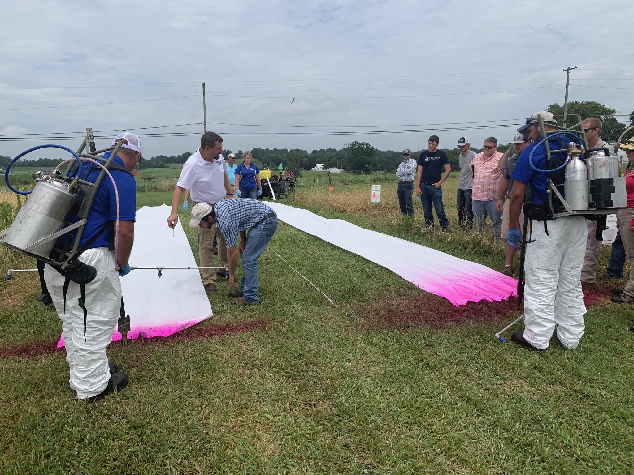 Travis Legleiter, center, explains to producers how nozzle size and boom height affect herbicide drift during the 2019 Spray Clinic. Photo by Lori Rogers, UK KATS coordinator.