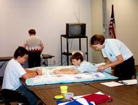 4-H members from Daviess County put the finishing touches on helping hand quilts that will be sent to young people who lost a family member in the Sept. 11 attack on the Pentagon.
