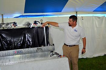 UK weed scientist Travis Legleiter demonstrates the influence nozzle design and pressure has on droplet size production. Photo by Katie Pratt, UK agricultural communications.