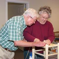 Raquel Congleton brought her husband Conley to help weave a stool bottom.